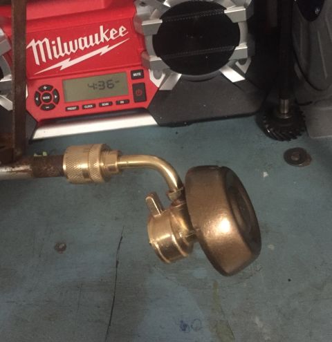 2014 Dodge 1500 - A Milwaukee radio and a brass fitting with a quick-connect coupler are shown in this close-up image.