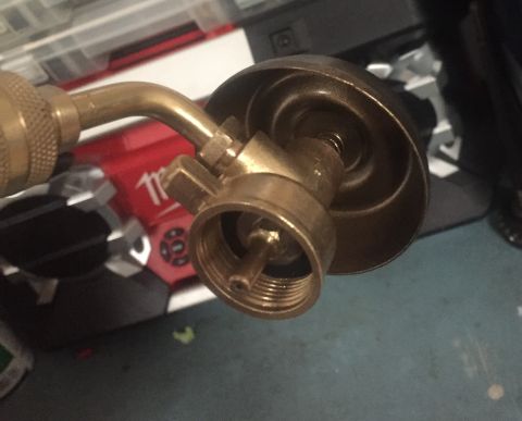 2014 Dodge 1500 - Close-up of a brass propane torch fitting, showing the threaded connection and valve mechanism.