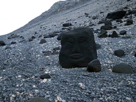 1996 Ford Bronco - A rock with a carved face sits on a desolate, rocky hillside.
