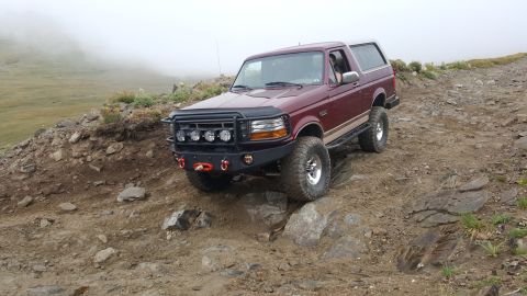 1996 Ford Bronco - This 1996 Ford Bronco is tackling a challenging off-road trail in a mountainous, foggy environment.