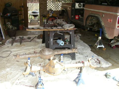 1995 Ford Bronco - Ford Bronco undergoing rear axle repair, with disassembled parts laid out.