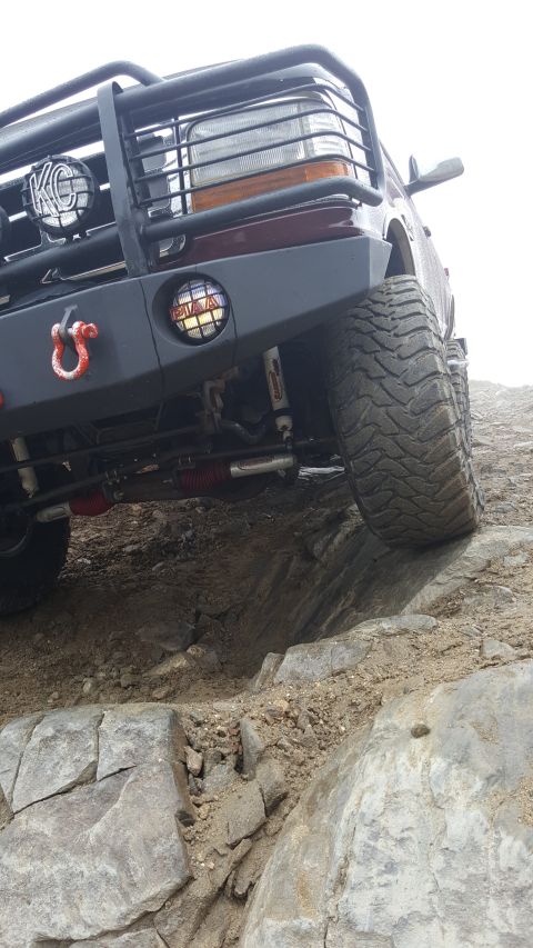 1996 Ford Bronco - This 1996 Ford Bronco navigates a rocky trail, its off-road capabilities with a heavy-duty bumper and aggressive tires.