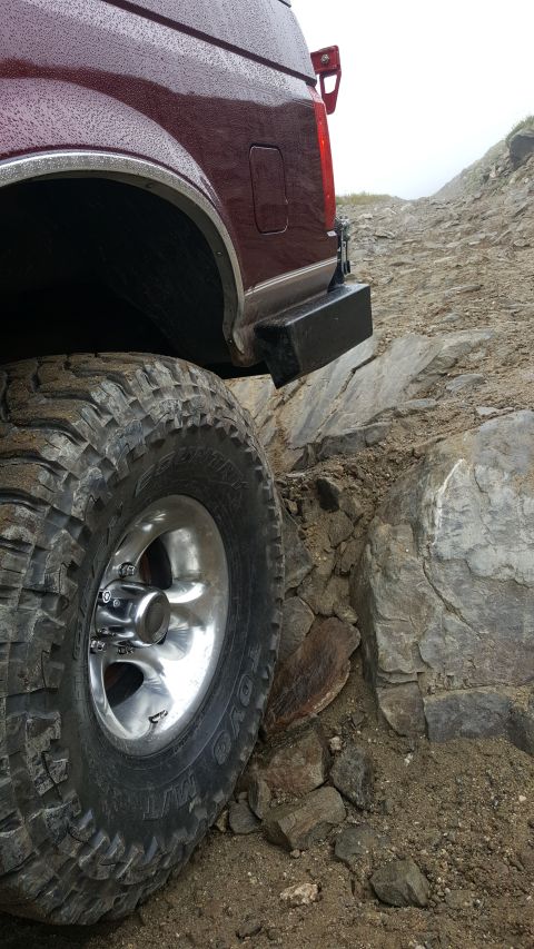 1996 Ford Bronco - Bronco's rear tire carefully maneuvers over rough, rocky terrain.