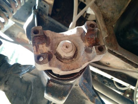 1992 Ford Bronco - ready to remove the pinion nut. it's 1 1/8 inch. used an impact gun while holding the yoke in place.