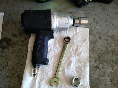 1992 Ford Bronco - Tools laid out on a paper towel, including an air impact wrench, a socket, a wrench, and a nut.