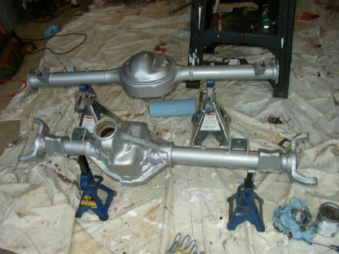 1995 Ford Bronco - Two freshly painted rear axle assemblies are set up on jack stands, ready for installation.