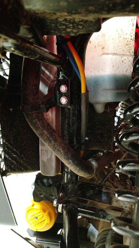 2016 Honda TRX 90 - Close-up view of an ATV's winch mount, showing cables and a yellow cap.