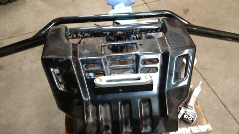 2016 Honda TRX 90 - This is a close-up view of an ATV's front bumper and winch assembly, likely removed for maintenance or modification.