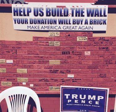 1995 Mercury Grand Marquis - A wall is covered in signatures and messages, with a sign for Trump Super Motors visible.