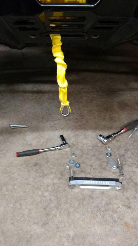2016 Honda TRX 90 - A winch part is shown with a yellow rope and tools, suggesting a repair or installation process.