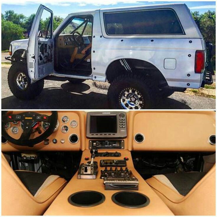 SUV with doors open, showing custom interior with racing steering wheel and large screen