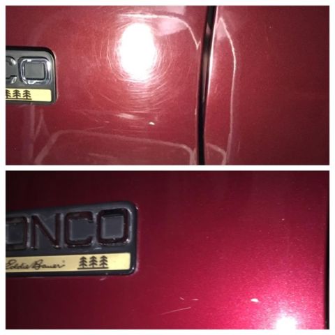 1996 Ford Bronco - Close-up of a red Ford Bronco Eddie Bauer badge showing paint swirl marks and scratches, with a comparison to the corrected finish.