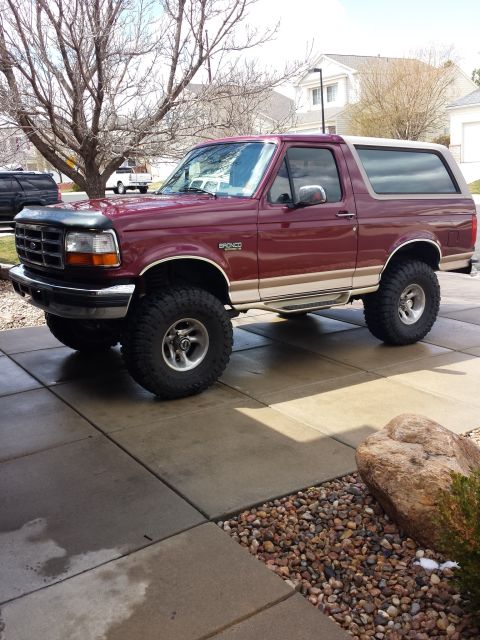 1996 Ford Bronco - This maroon 1996 Ford Bronco features tan two-tone trim and an aftermarket lifted suspension.