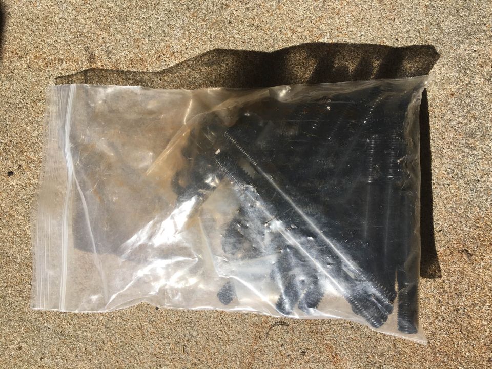 Bag of black valve keepers on concrete