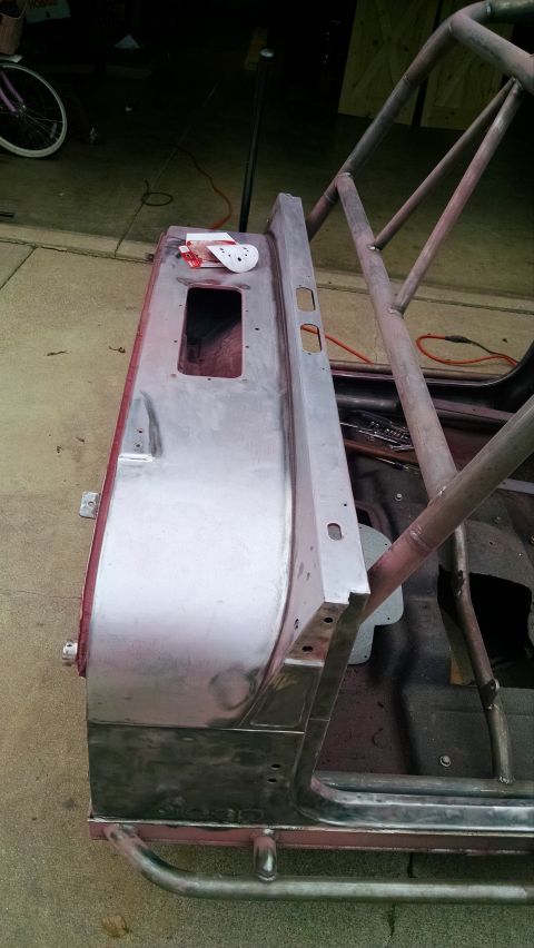 1985 Jeep CJ7 - Close-up of a Jeep CJ body panel undergoing modification, with a roll cage structure integrated.