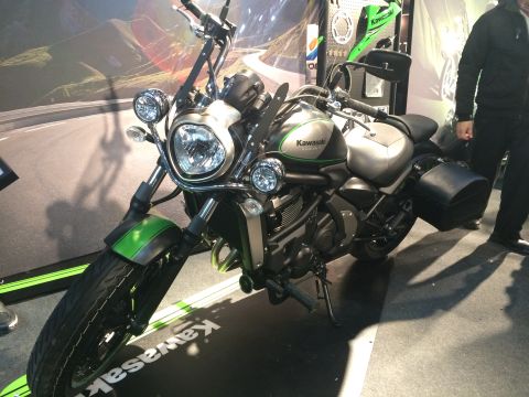 1987 Ford Bronco - A silver and green Kawasaki motorcycle is displayed indoors with saddlebags attached.