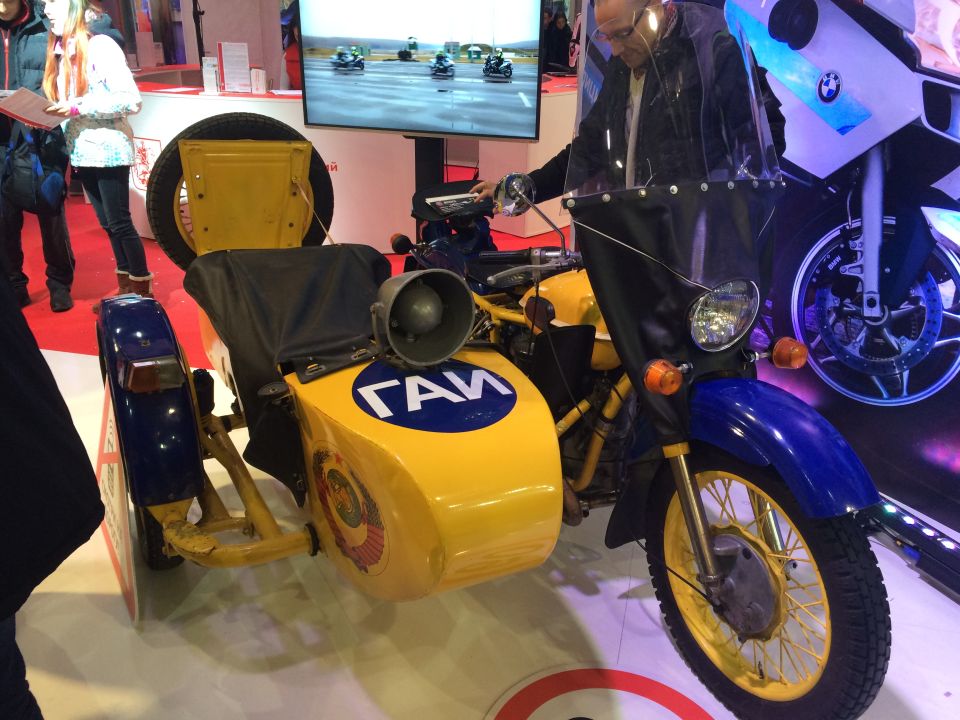 Yellow and blue motorcycle with sidecar, a large siren and 'ГЛМ' text on the sidecar