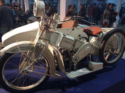 1987 Ford Bronco - A vintage motorcycle with a sidecar is displayed indoors, with people in the background.