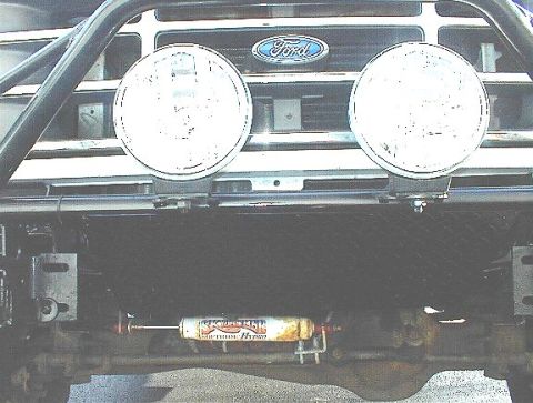 1995 Ford Bronco - Front view of a 1995 Ford Bronco showing the grille, lights, and a shock absorber.