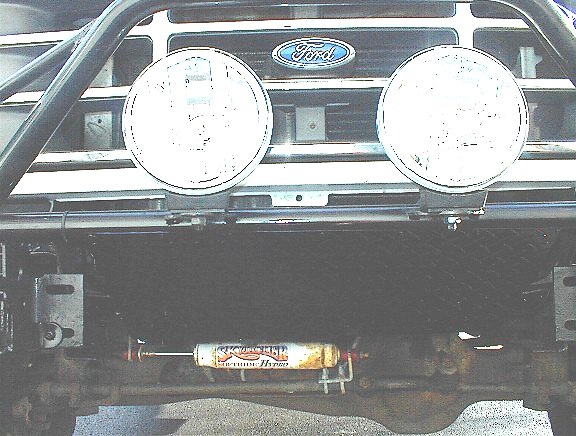 1995 Ford Bronco front grille with two round lights and a Rancho shock absorber mounted below