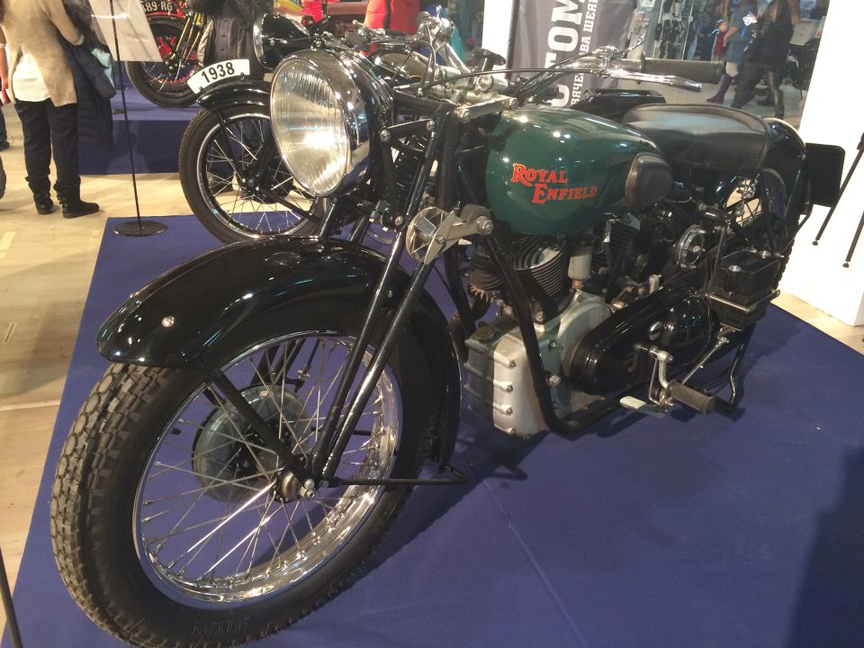 1938 Royal Enfield motorcycle with green tank and red lettering, another motorcycle behind it