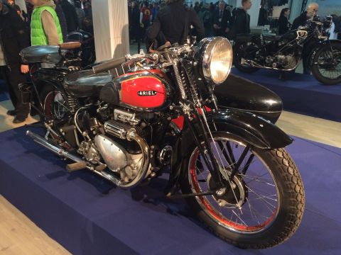 1987 Ford Bronco - A vintage Ariel motorcycle with a sidecar is displayed indoors on a blue carpet.