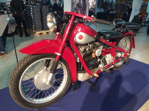 1987 Ford Bronco - A vintage red motorcycle is displayed indoors on a blue mat.