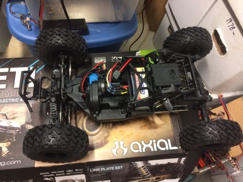 1989 Ford Bronco - The underside of a remote control car chassis reveals its internal components and suspension system.