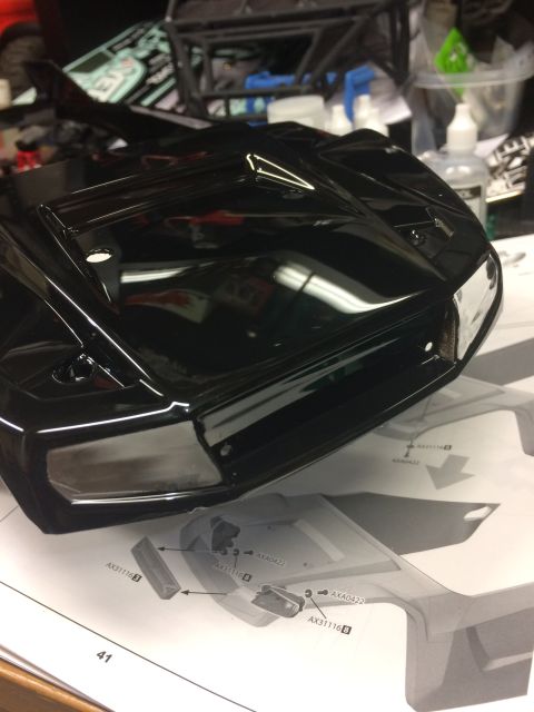 1989 Ford Bronco - RC car body and assembly instructions are on a workbench.
