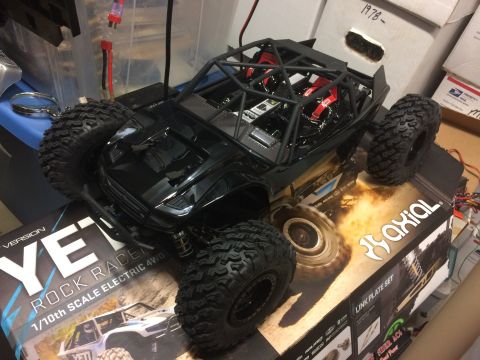1989 Ford Bronco - A 1/10th scale electric 4WD rock racer toy car is displayed on its packaging.