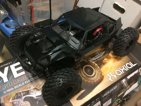 1989 Ford Bronco - A black remote control rock crawler is displayed on its packaging, highlighting its off-road capabilities.