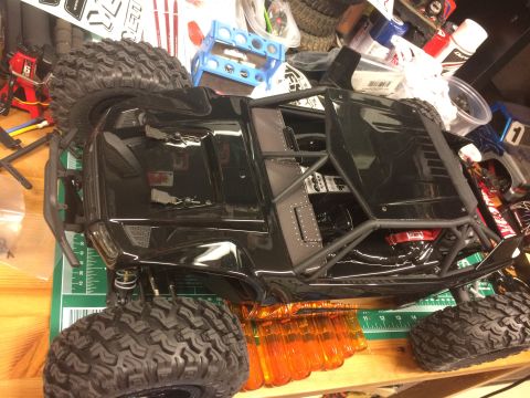 1989 Ford Bronco - A detailed view of a black RC rock crawler, its interior and roll cage structure.