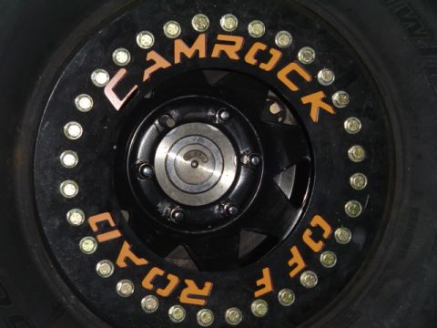 1993 Ford Bronco - This image shows a close-up of a custom off-road wheel with brand lettering.