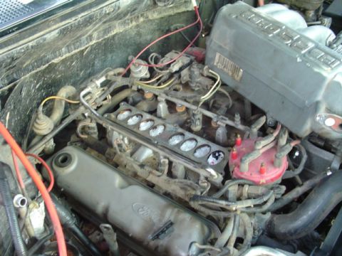 1993 Ford Bronco - The engine bay of a 1993 Ford Bronco is visible, with the V8 engine components clearly displayed.