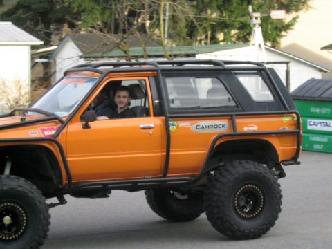 1993 Ford Bronco - Modified 1984 Toyota 4Runner off-road SUV with a full roll cage and aggressive tires.