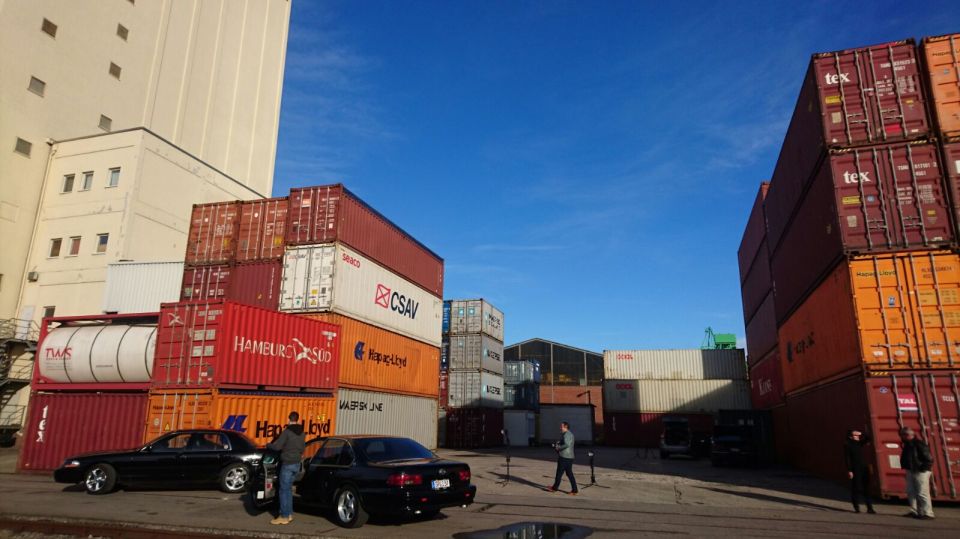 Black 2003 Mercury Marauder parked in a shipping yard with containers