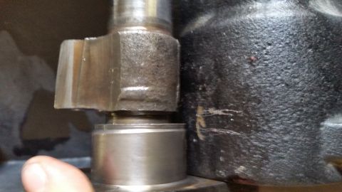 1979 Ford Bronco - A close-up view shows a metal part with a hexagonal nut and a textured black housing, possibly from a vehicle's engine or drivetrain.