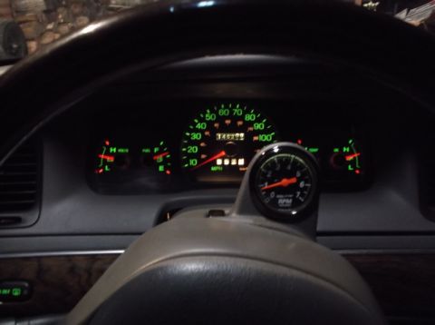 1999 Mercury Grand Marquis - The image shows the interior of a vehicle, focusing on the dashboard gauges. A speedometer, tachometer, fuel gauge, and voltmeter are visib…