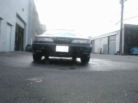 1990 Ford Thunderbird - Front view of a black 1990 Ford Thunderbird parked in an industrial area.