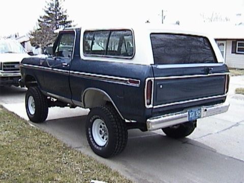 1995 Ford Bronco - Rear view of a lifted 1978 Ford Bronco with a two-tone paint scheme and aftermarket wheels.