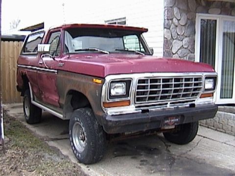 1995 Ford Bronco - This 1978 Ford Bronco features a prominent chrome grille and a two-tone red and brown paint scheme.