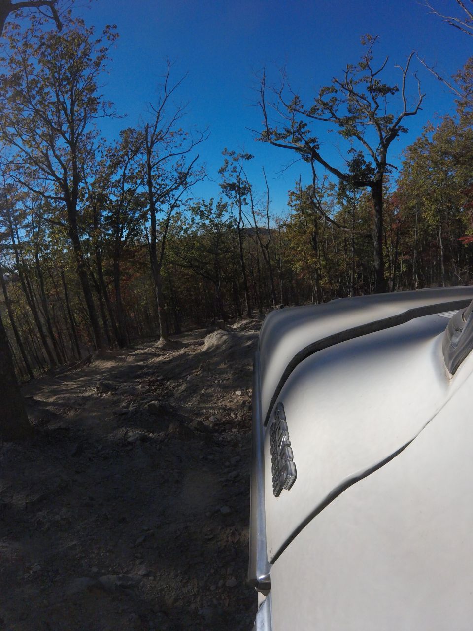 1979 Ford Bronco driving on a rocky trail