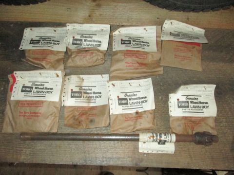 1986 Yamaha BLASTER - Collection of vintage Toro Wheel Horse Lawn-Boy parts and accessories, along with a metal shaft.