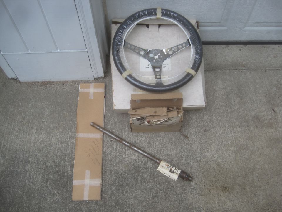 Steering wheel and shaft with visible labels and cardboard packaging