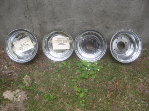 1986 Yamaha BLASTER - Four chrome wheels are displayed on the ground, with two still bearing their original labels.
