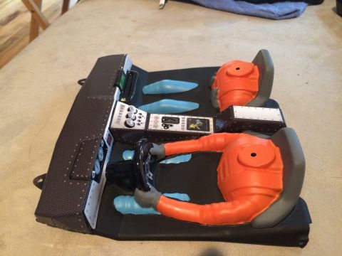 1989 Ford Bronco - This is a toy model of a vehicle's interior, complete with a dashboard and figures.