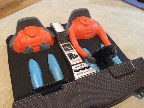 1989 Ford Bronco - This is a toy representation of a car's interior, orange seats and blue leg sections.