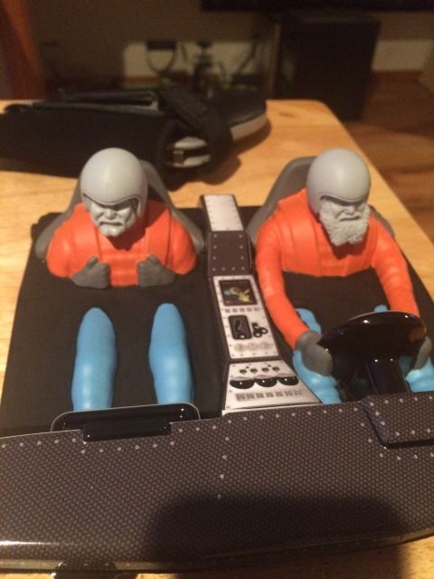 1989 Ford Bronco - This is a toy model of a vehicle's interior, complete with two seated figures and a dashboard.