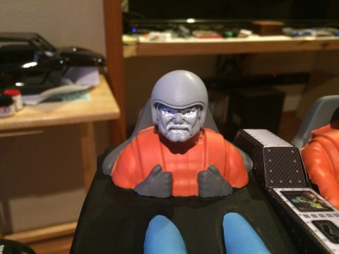 1989 Ford Bronco - A model figure with a helmet and orange suit sits in a cockpit, with another figure visible to the right.