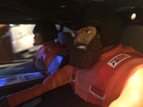 1989 Ford Bronco - Interior view of a toy race car, showing two figures in racing attire.